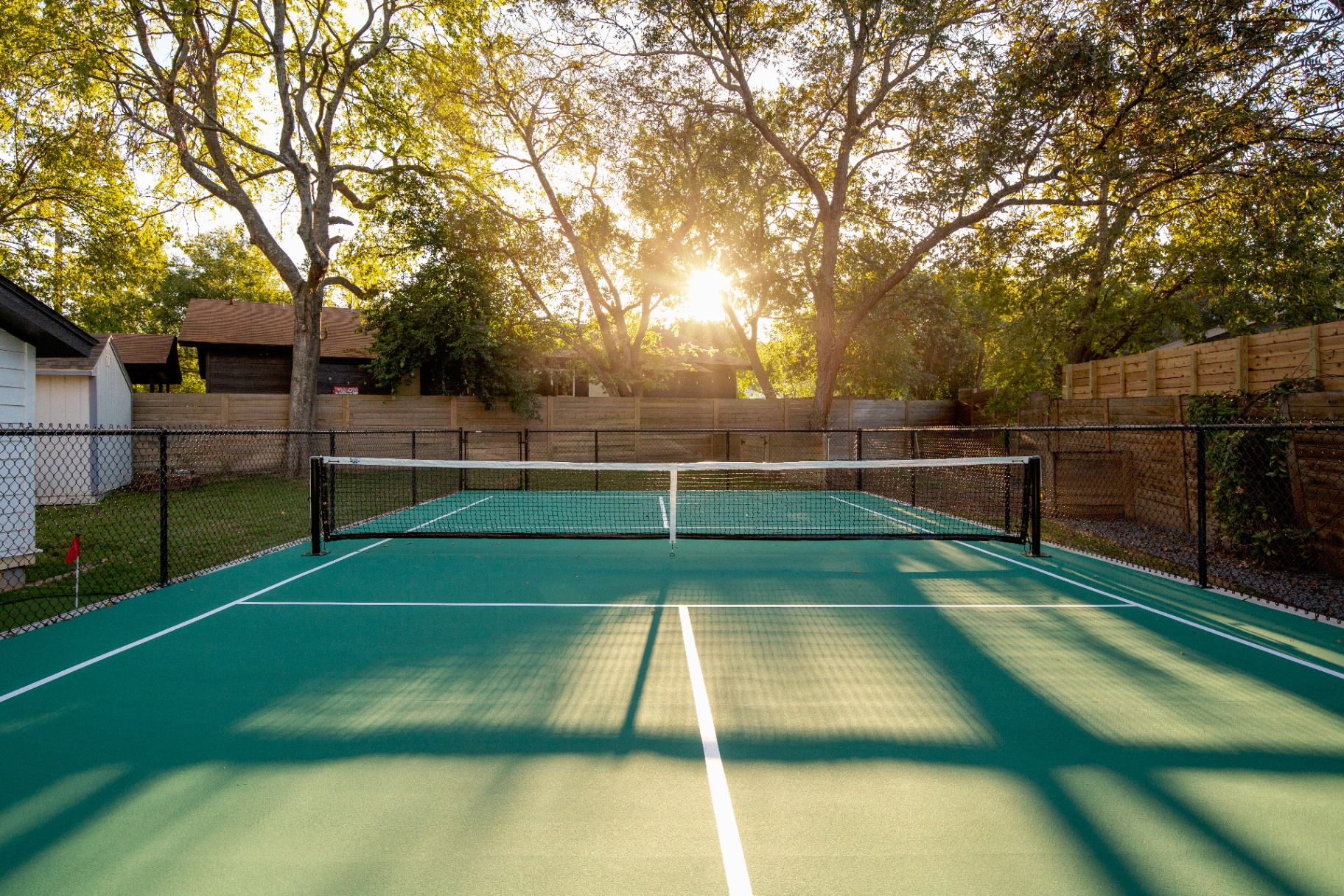 Backyard pickleball court at golden hour