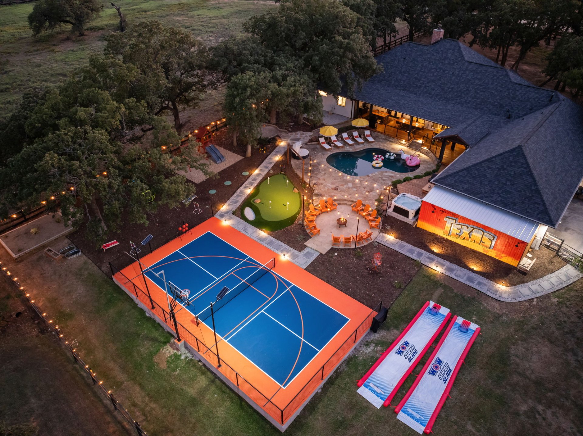 Aerial view of Texas estate with pickleball court, pool, and putting green